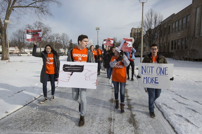 Adams High School student Logan Reimbold-Thomas, center, leads students during the National Walkout Day rally at Adams on March 14. He and about three dozen area high school students will travel to Washington, D.C., for Saturday's "March for our Lives" national event to draw attention to gun violence in schools. Tribune Photo/SANTIAGO FLORES