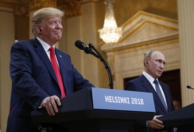 U.S. President Donald Trump, left, smiles beside Russian President Vladimir Putin during a news conference after their meeting at the Presidential Palace in Helsinki, Finland on July 16, 2018.