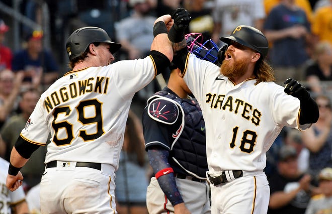 Pittsburgh Pirates' John Nogowski, left, congratulates Ben Gamel after Gamel hit a two-run home run against the Atlanta Braves in the fourth inning of a baseball game Monday, July 5, 2021, in Pittsburgh. (Matt Freed/Pittsburgh Post-Gazette via AP)
