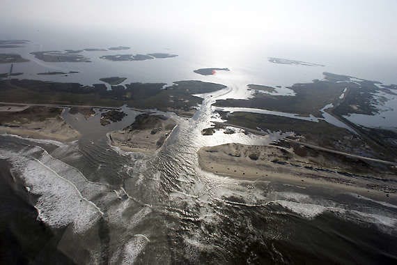 A flooded road is seen Aug. 28, 2011, on Hatteras Island, N.C., after Hurricane Irene swept through the area the previous day, cutting the roadway in five locations. Jim R. Bounds | Associated Press