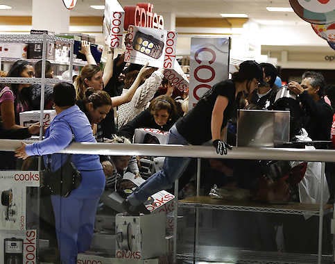 Shoppers rush to grab electric griddles and slow cookers on sale for $8 shortly after the doors opened at a J.C. Penney story Friday in Las Vegas.Julie Jacobson | Associated Press
