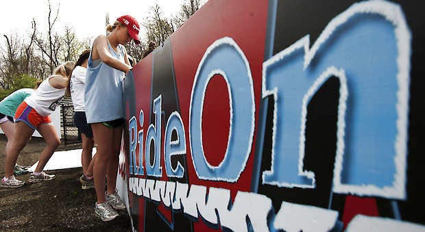 Paige Gruber and other Indiana University Student Foundation members place boards along the track for the Little 500 races. The women’s race festivities begin at 4 p.m. Friday and the men start at 2 p.m. Saturday. David Snodgress | Herald-Times