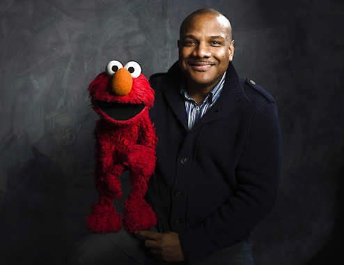 Elmo puppeteer Kevin Clash poses in 2011 with the “Sesame Street” muppet in the Fender Music Lodge during the 2011 Sundance Film Festival in Park City, Utah. Victoria Will | Associated Press