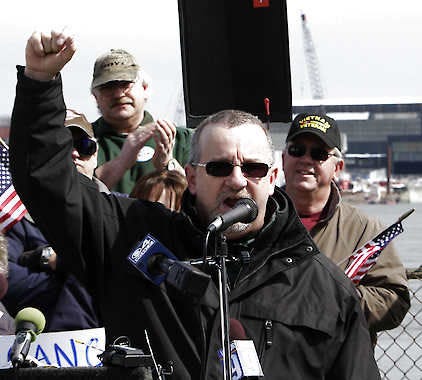 John Joyal speaks Thursday in Portsmouth, N.H., at a rally of Portsmouth Naval Shipyard workers from Maine and New Hampshire. The rally called on Congress to cancel automatic budget cuts that will affect the workers’ pay. Jim Cole | Associated Press