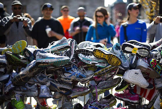 A collection of running shoes, seen Saturday in Boston’s Copley Square, are part of a makeshift memorial honoring the victims of the Boston Marathon bombing in Boston, Mass.Robert F. Bukaty | Associated Press