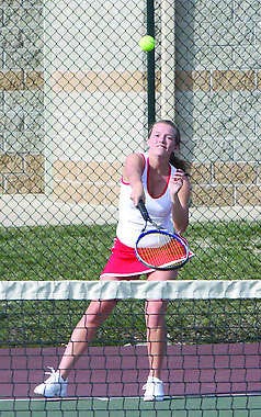 Krista Swafford, a Martinsville senior, launches a served during the Artesians' home match with Brown County. Photo by Steve Page.