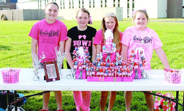 Maddie Morris, Kairden Jones, Jacelyn Stephey and Tori Lynn McQueen sold Bri Pops during the walk-a-thon to raise money for the Pediatric Brain Tumor Foundation in memory of Bri McQueen. The girls had to write Mr. Spencer a letter asking permission to sell the ÒBri PopsÓ and explain why they wanted to do this. Submitted photo.