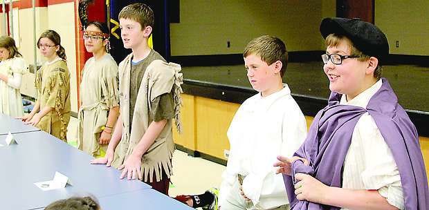 Spencer Skaggs, right, recites a speech he wrote about explorer Amerigo Vespucci on Thursday morning at Smith Elementary School. Fifth-graders in Rachel Crabb and Stephanie Johnson’s classes researched people from throughout U.S. history, wrote a speech and memorized it for the third-annual living history museum event at the school. Spectators could push a “button” in front of each student to learn about the person they dressed up as. Photo by Michael Reschke.