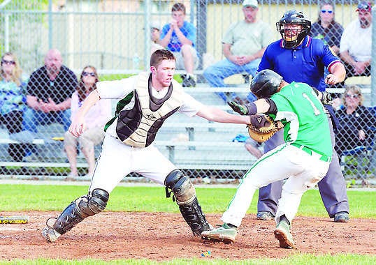 Monrovia catcher Davis Noel tags out Cloverdale’s Austin Mannan (11) to keep the score tied at 0-0 in the top of the fifth inning Wednesday during sectional play hosted by Speedway. Photo by Eric Thieszen.