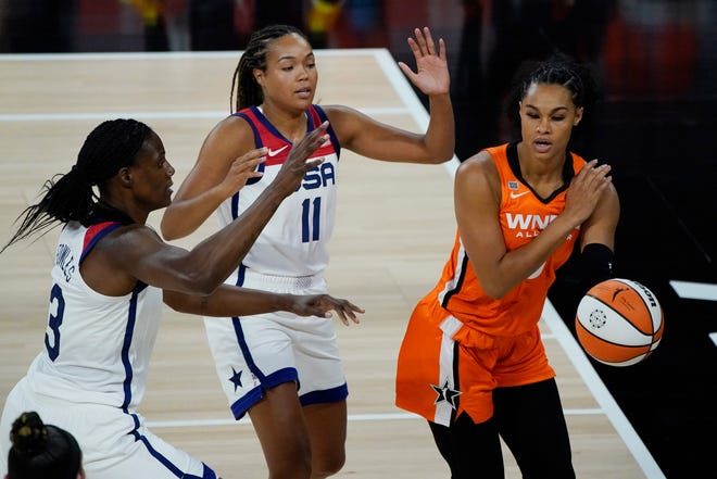 Team WNBA's Satou Sabally passes around Napheesa Collier, center, and Sylvia Fowles of the U.S. national team during the first half of Wednesday's WNBA All-Star Game in Las Vegas.