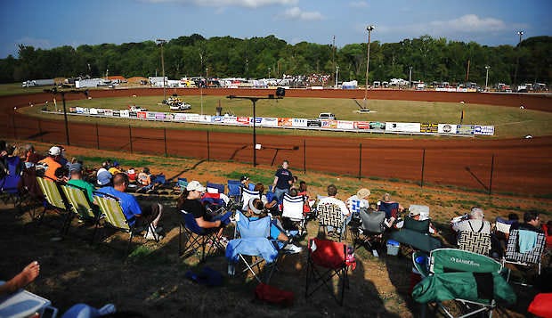 Fans sit on the hillside overlooking the Bloomington Speedway during the World of Outlaws program Aug. 3, 2013. Racing continues this summer at the speedway on Bloomington's south side.