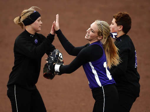 Bloomington South pitcher Olivia White celebrates with teammates Mena Fulton (left) and Hannah Wright during Friday’s game against Bloomington North at Andy Mohr Field.Chris Howell | Herald-Times