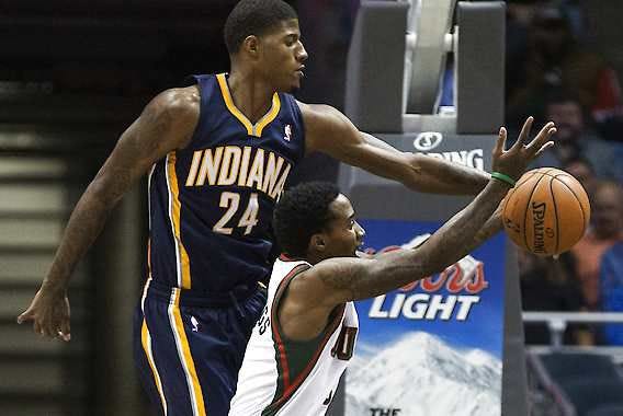 Indiana’s Paul George (left) blocks a shot by Milwaukee’s Brandon Jennings during the second half Wednesday.Tom Lynn | Associated Press