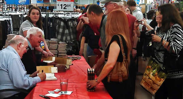 Former Indiana basketball coach Bob Knight and former H-T sports editor Bob Hammel (left) autograph copies of their new book at Wal-Mart Thursday. Jon Blau | Herald-Times