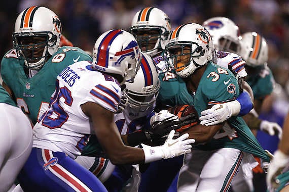 Miami’s Marcus Thigpen is wrapped up during a punt return in the first half Thursday night against the Buffalo Bills. The former Indiana University standout returned a kickoff 96 yards for a touchdown in the first quarter. Bill Wippert | Associated Press