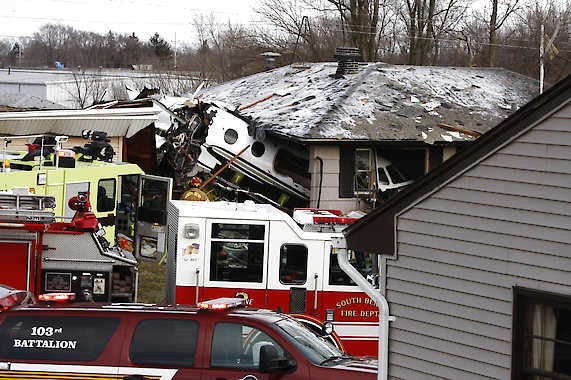 The front end of a Hawker Beechcraft Premier jet sits in a room of a home on Iowa Street in South Bend Sunday. Authorities say a private jet apparently experienced mechanical trouble and crashed. Two people aboard the plane were killed. Mike Hartman | South Bend Tribune, Associated Press