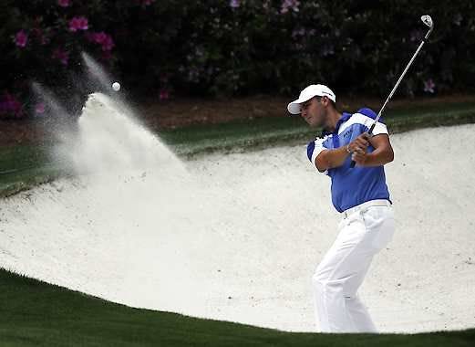 Martin Kaymer, of Germany, chips out of a bunker on the 13th hole during the first round of the Masters golf tournament Thursday, April 11, 2013, in Augusta, Ga. (AP Photo/Charlie Riedel)