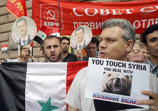 Dozens of pro-Assad Syrians and Russian communists rally Friday outside the U.S. Embassy in Moscow, Russia. Misha Japaridze | Associated Press