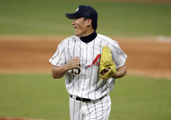 FILE - In this Aug. 20, 2008, file photo, Japan's pitcher Masahiro Tanaka reactas after watching second baseman Masahiro i Araki knock down what could have been a base hit by the USA's Taylor Teagarden for the third out in the sixth inning in their baseball game at the Beijing 2008 Olympics in Beijing. The New York Yankees and Tanaka agreed on Wednesday, Jan. 22, 2014, to a $155 million, seven-year contract. In addition to the deal with the pitcher, the Yankees must pay a $20 million fee to the Japanese team of the 25-year-old right-hander, the Rakuten Golden Eagles. (AP Photo/Kathy Willens, File)