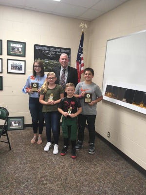 MONROVIA — At Monday night’s meeting of the Monroe-Gregg School Board, the school board recognized the students of the month for September. The Students of the Month for Monrovia Elementary School were Bryce Goodwin and Ciara Elliott. The Monrovia Middle School Student of the Month was Zeb Poland. The Monrovia High School Student of the Month was Melanie Courtney. From left, Melanie Courtney, Ciara Elliot, Bryce Goodwin and Zeb Poland pose with Monroe-Gregg School Superintendent Kirk Freeman. The students respective principals presented them with plaques which were provided by the Monrovia Alumni Association. Photo by Anthony Woodside.