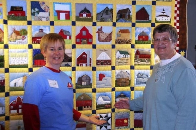 Danielle Bachant-Bell of BRI (left) and Linda Long, who made the Monroe County square, stand in front of the bicentennial barn quilt. Courtesy photo