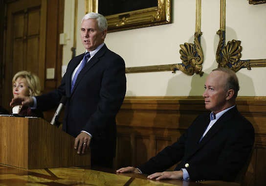 Indiana Governor-elect Mike Pence left, speaks at a news conference at the Statehouse Wednesday, Nov. 7, 2012, in Indianapolis. Gov. Mitch Daniels listen as Pence speaks. (AP Photo/Darron Cummings)