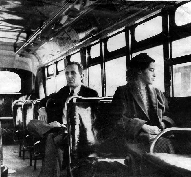 This undated file photo shows Rosa Parks riding on the Montgomery Area Transit System bus in Montgomery, Ala. The Volusia County School District temporarily pulled a state-approved book about the civil rights pioneer from classrooms and subsequently put it back, after a teacher complained about the content and state leaders said it was OK.   (AP Photo/Daily Advertiser, File)