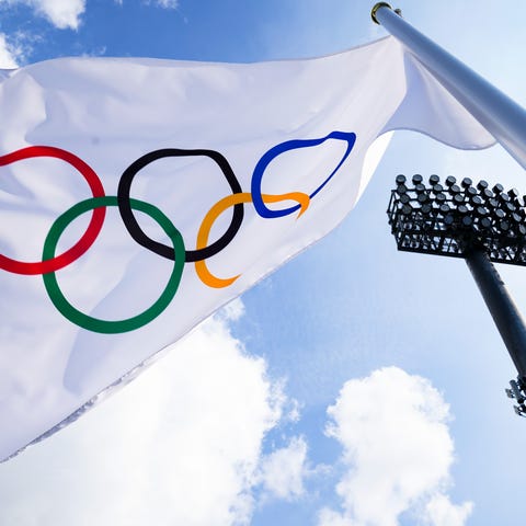 A flag bearing the Olympic Rings is displayed on t