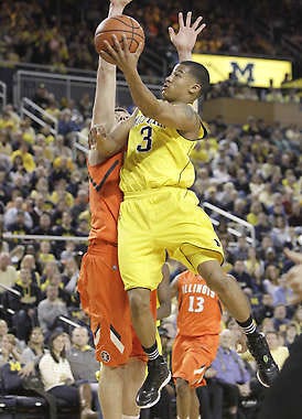 Michigan’s Trey Burke (3) shoots over Illinois’ Tyler Griffey during the first half Sunday in Ann Arbor, Mich.Carlos Osorio | Associated Press