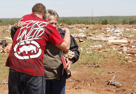 Shelly Hobbie, right, the mother of tornado victim Frank “Skip” Hobbie, is hugged Sunday by Cory Brown, left, at the site of what is left of her son’s mobile home in Woodward, Okla. Sue Ogrocki | Associated Press