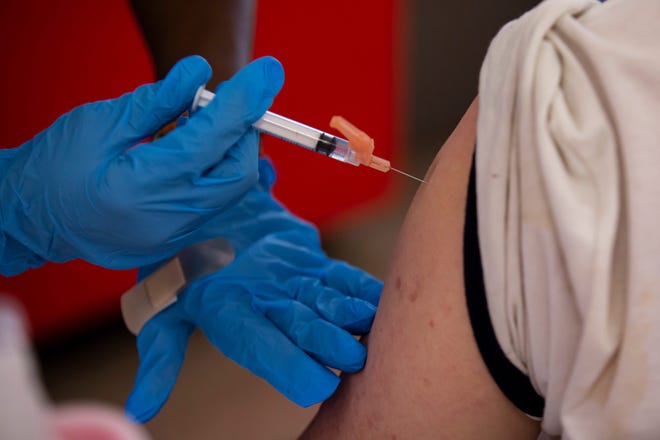 A patient receives a COVID-19 vaccination shot at Sullivant Gardens Community Center in Columbus, Ohio, on July 15.