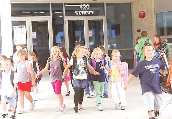 BEDFORD — Stalker Elementary School students walk through the breezeway after school Monday afternoon. Indiana schools on Monday received letter grades from the Indiana Department of Education for the first time. (Times-Mail / GARET COBB)