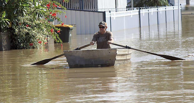 A man rows a boat along a flooded street Wednesday in Rockhampton, Australia.Chris Wills | Associated Press