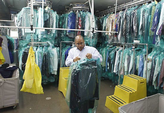 Richard Burden retrieves cleaned clothing for a customer Thursday at Bloomington Cleaners. The local dry cleaning business had perc-contaminated soil removed from its facility at 317 W. 17th St. It says it now uses an eco-friendly cleaning solvent called Solvair, instead of perchloroethylene, which the EPA considers a hazardous substance.Jeremy Hogan | Herald-Times