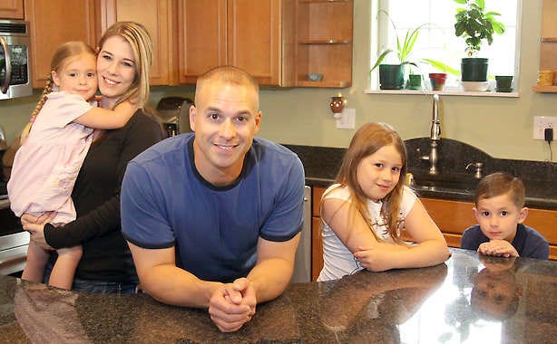 James Tritle, his wife, Angela, and their children BreAnna, Makayla and Cameron pose for a photo at their home in North Pole, Alaska. Tritle won the title “Hottest Dad” in an iVillage contest. Tim Edsell | Fairbanks Daily News-Miner, Associated Press