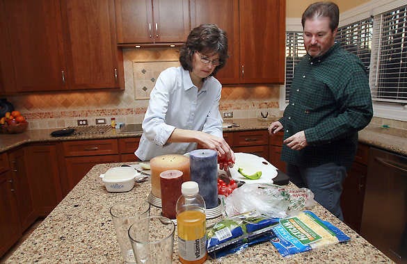 Beverly and Eugene Murray prepare dinner Jan. 14 at their home in Cary, N.C. As the economy improves and families have more spending money, they’re still saving restaurants for special occasions.Gerry Broome | Associated Press
