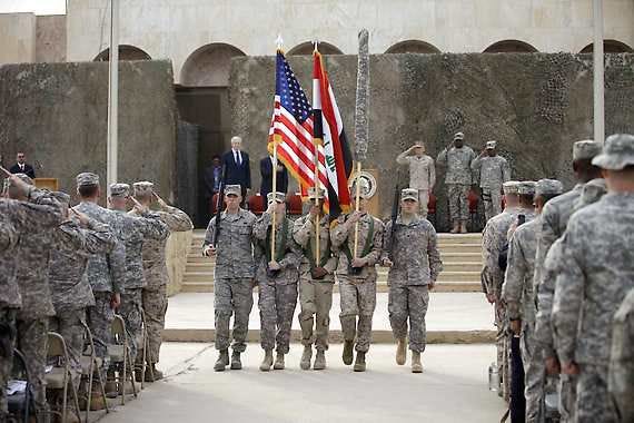 The U.S. flag, Iraq flag, and the U.S. Forces-Iraq colors are carried during ceremonies Thursday in Baghdad marking the end of the U.S. military mission in Iraq.Khalid Mohammed | Associated Press