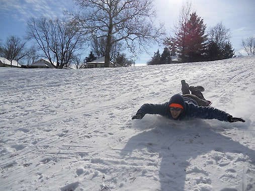 Lee Hadley sleds down the hill at Rev. Ernest D. Butler Park in Bloomington on a snowy January day.Courtesy photo