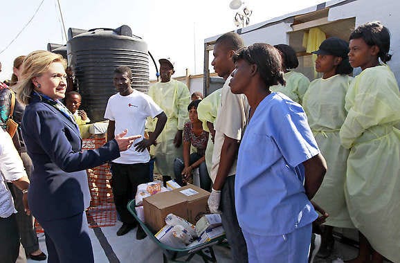Secretary of State Hillary Rodham Clinton talks with workers Sunday as she visits Partners in Health Cholera Treatment Center in Port-au-Prince, Haiti.Alex Brandon | Associated Press