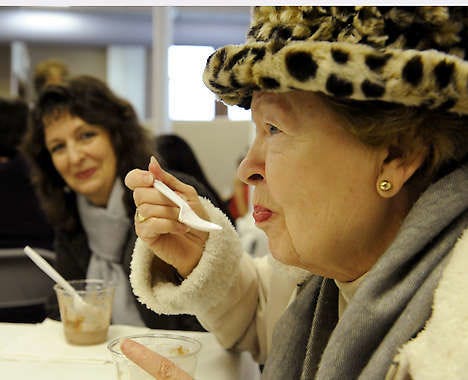 Peggy Thornton, right, enjoys an ice cream sundae Saturday with her daughter, Meg, at the Monroe County History Center during one of the many Week of Chocolate fundraising events that benefit local nonprofit agencies. Monty Howell | Herald-Times