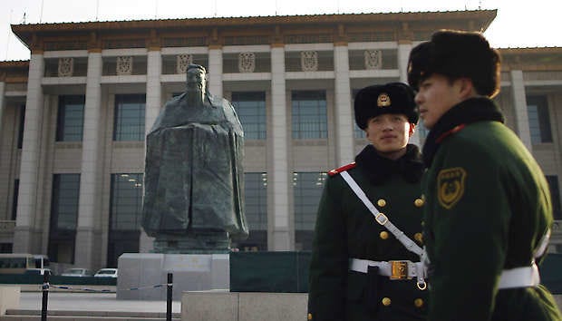 Chinese paramilitary policemen stand guard Wednesday in front of a sculpture of the ancient philosopher Confucius on display in near the Tiananmen Square in Beijing, China.Andy Wong | Associated Press