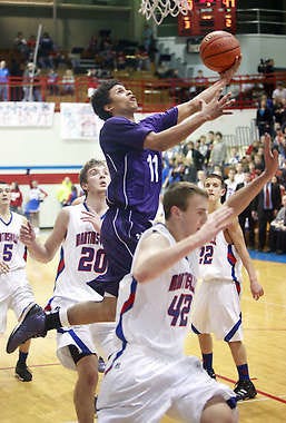 South’s Dee Davis (11) goes to the basket against Martinsville’s Jason Ray (20) and Greg Spina (42) during Friday night’s game at John R. Wooden Gymnasium in Martinsville.Jeremy Hogan | Herald-Times