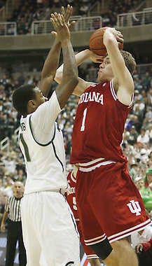 In the last second of overtime Jordan Hulls (1) shoots against Michigan State\'s Keith Appling (11). Jeremy Hogan | Herald-Times