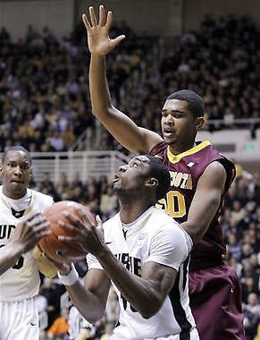Purdue’s E’Twaun Moore looks up at Minnesota center Ralph Sampson III in Saturday’s game in West LafayetteMichael Conroy | Associated Press