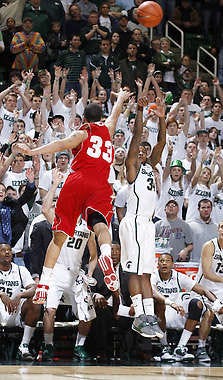 Michigan State’s Korie Lucious shoots a 3-pointer over Wisconsin’s Rob Wilson to force overtime in Tuesday’s game.Al Goldis | Associated Press