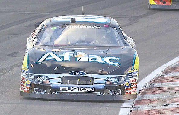 MADISON, Ill. — Carl Edwards drives through a turn early in a Nationwide Series race, which he won. Edwards sees no reason why he shouldn’t compete for the NASCAR Sprint Cup and the sport’s second-tier title at the same time. (Associated Press).