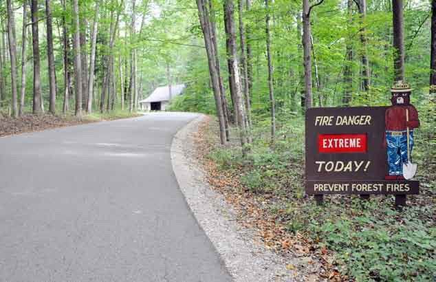 As the sign above shows, an unusually long dry spell this summer has elevated the fire danger level at McCormick’s Creek State Park east of Spencer to “Extreme.” (Staff Photo by Travis Curry)