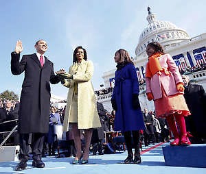 Barack Obama takes the oath of office as his wife Michelle, holds the Lincoln Bible and daughters Sasha, right, and Malia watch during his first inauguration Jan. 21, 2009.
