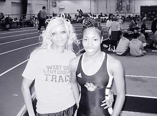 Veronica Williams, coach of the Gary Westside Cougars track team, stands with Mary Bell, a senior on the team, at the Harry Gladstein Fieldhouse on the IU campus Saturday. The team was aided in traveling to the meet at IU by former basketball coach Ken Carter. The story of how Carter pushed his students to succeed was immortalized in the movie “Coach Carter.” Brady Gillihan | Herald-Times