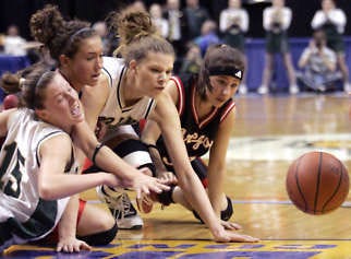 Wood Memorial’s Shadoe Besing (left) and Kaiti Cochren go after a loose ball with Oregon-Davis’ Kelsey Minix (right) and Sarah Konkey in Saturday’s 1A state championship game. Tom Strattman | Associated Press